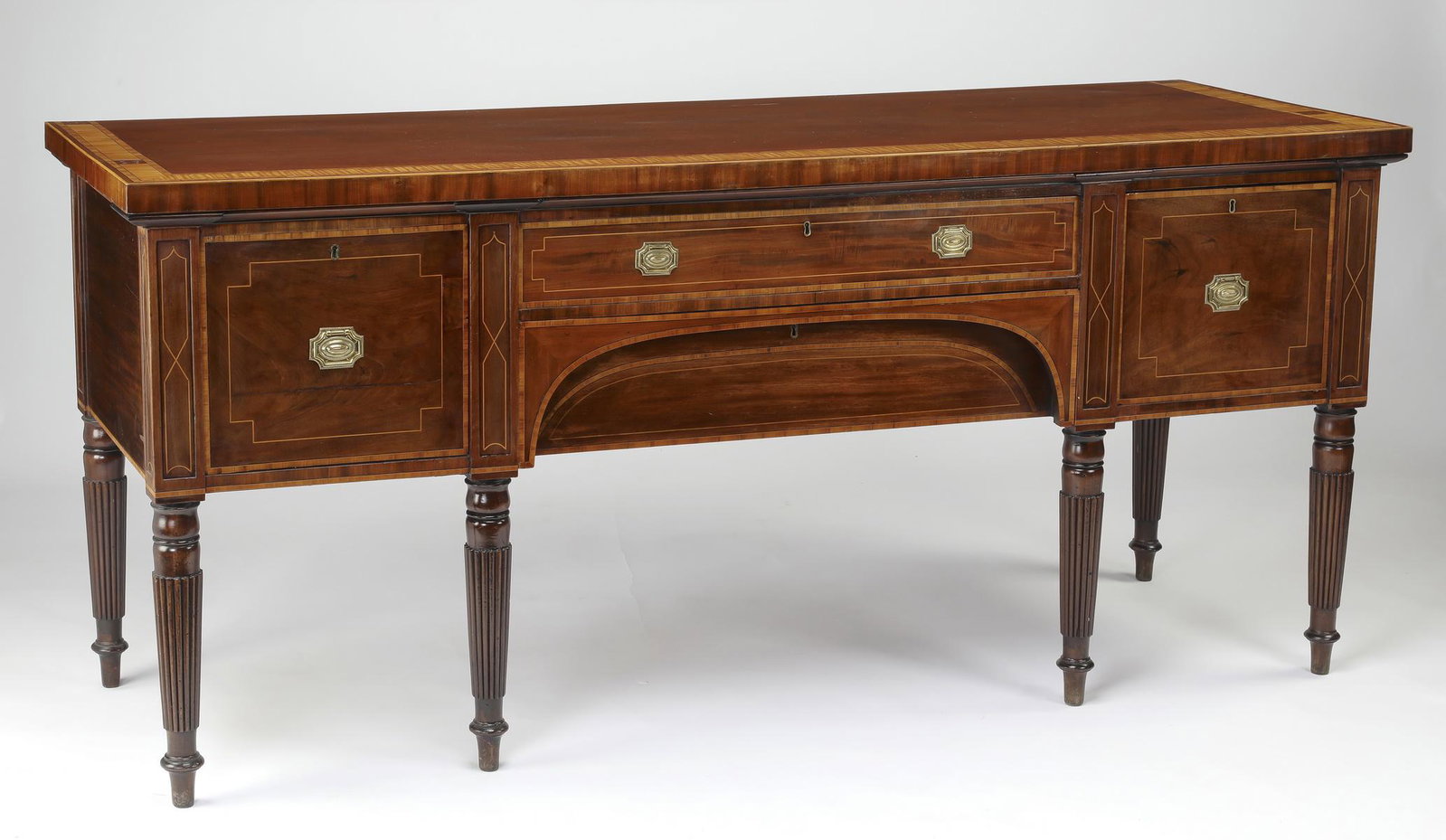 19th c. Georgian style mahogany & satinwood sideboard: 19th century mahogany sideboard in the Georgian taste, the rectangular top with satinwood banding surmounting the conforming two-drawer case, flanked by one drawer and one door opening to reveal a she