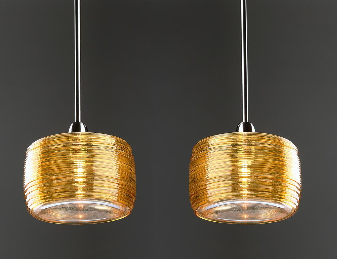 (2) Murano glass 'Damasco' pendants by Vistosi: Pair of contemporary amber Murano glass pendants, designed by Paolo Crepax for Vistosi, from the 'Damasco' series, each of barrel form, ornamented by continuously trailed amber glass around a clear gl