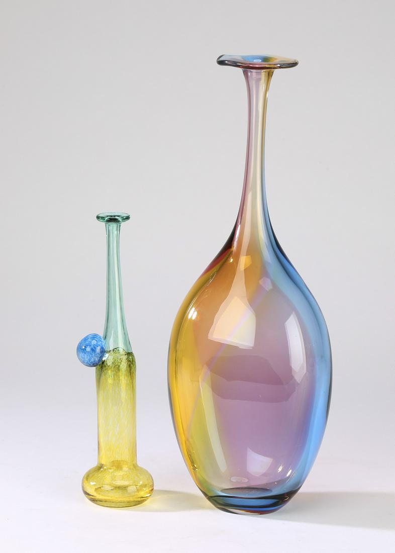 (2) Signed Kosta Boda art glass vases: Two Kosta Boda art glass vases, the first a 'Windpipe' vase designed by Bertil Vallien and executed in celadon and daffodil glass, 6.5"h x 1.75"w; together with, a 'Fidji' vase designed by Kjell Engma