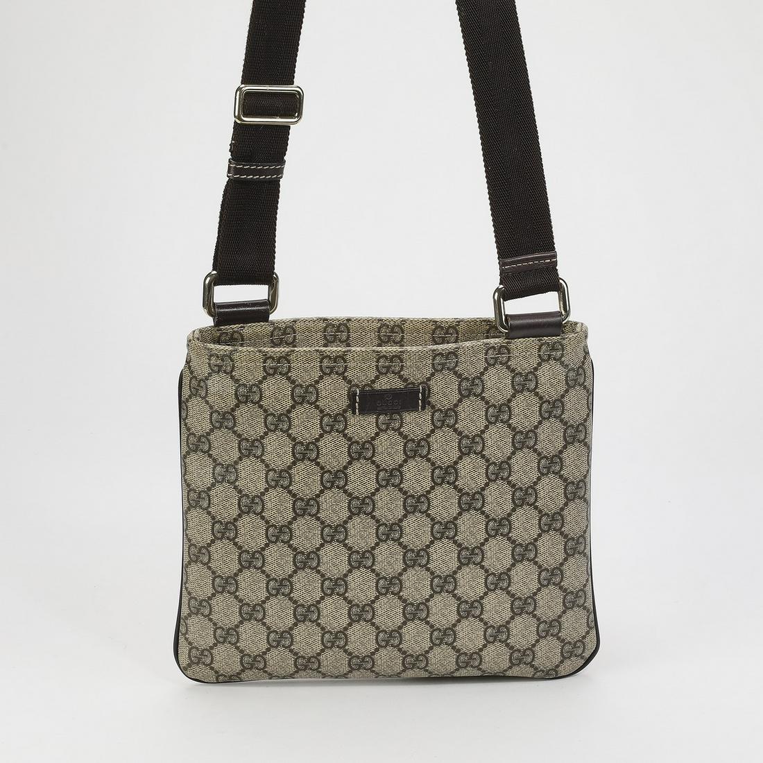 Authentic Gucci GG Supreme Cross Body Messenger Bag: Authentic Gucci GG Supreme Cross Body Messenger bag, having an adjustable shoulder strap and ruthenium hardware, the zip closure opening to a fabric interior with a single pocket, serial number 201538