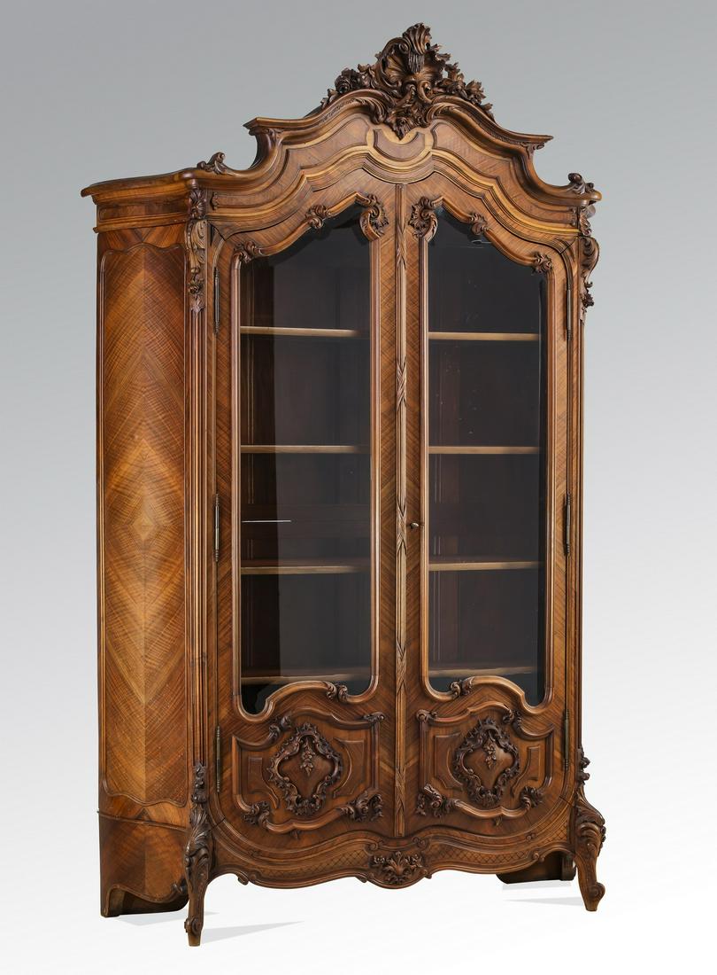 19th c. French Rococo style satinwood vitrine: 19th century French Rococo style satinwood vitrine, centering an asymmetrical foliate cartouche in a bow shaped pediment, over a conforming cabinet with book matched curving side panels, fitted with t