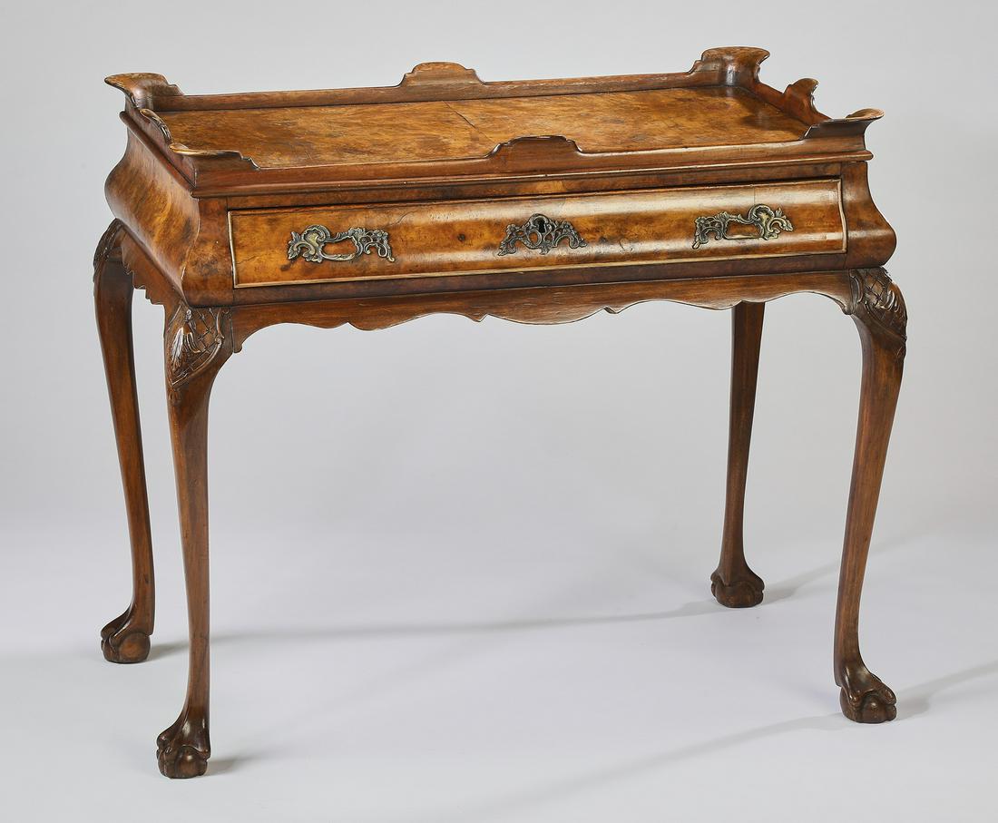 Early 20th c. George III style burlwood tea table: George III style burlwood tea table, early 20th century, having a scalloped gallery capturing the veneered burl surface surmounting one long drawer above a scalloped apron, rising on cabriole legs wit