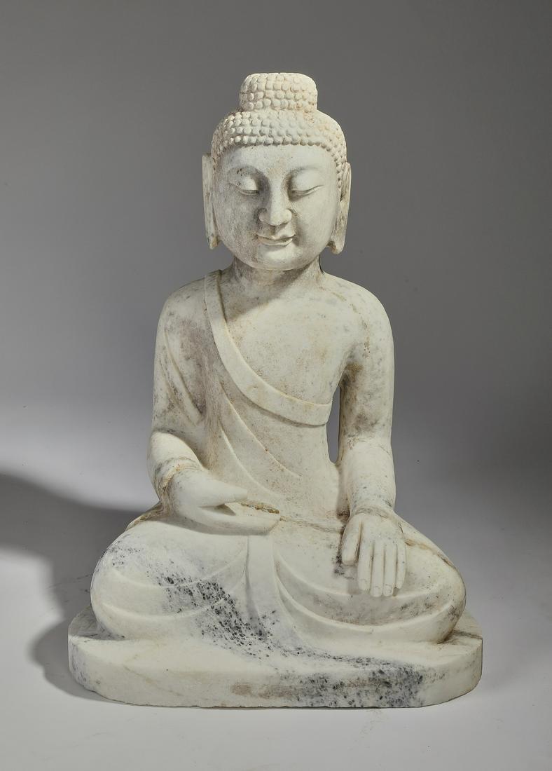 Contemporary carved marble Buddha sculpture, 24"h: Contemporary carved marble Buddha sculpture, having stretched lobes and a peaceful meditative expression, wearing draped garments and seated in the Sukhasana pose, 24"h x 17"w x 13"d.