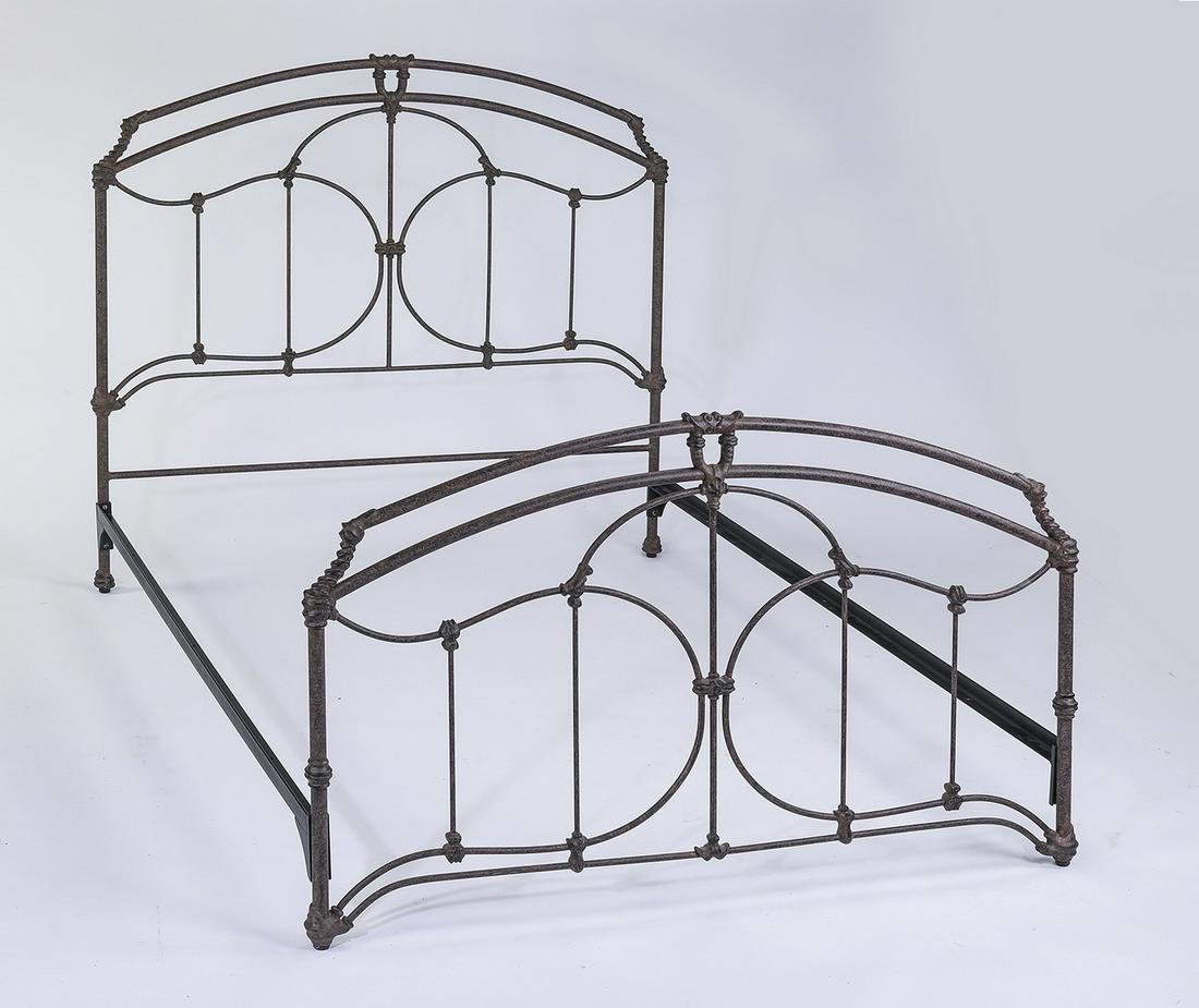 Provincial inspired faux patinated iron queen bed: Provincial inspired queen iron bed, of arched form with scrollwork with an applied faux patinated finish, 56"h x 60"w x 84"d, internal dimensions 59"w x 81"d.