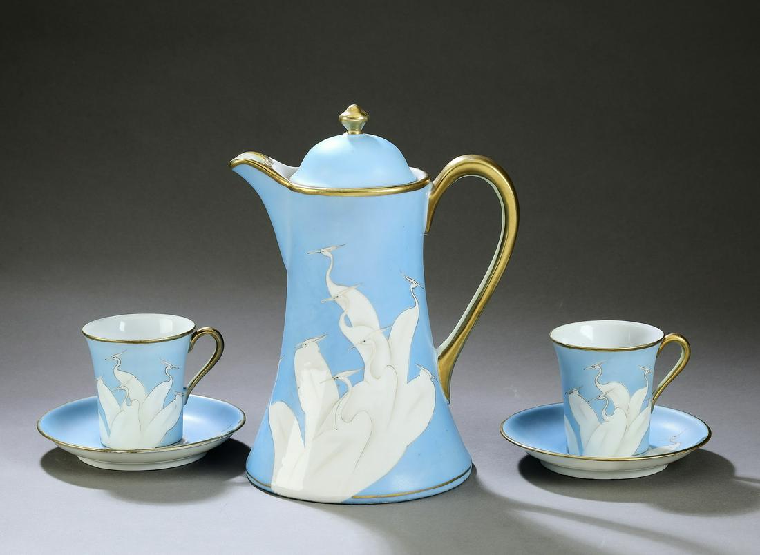 Hand painted Nippon chocolate tete-a-tete, w/ cranes: Hand painted Nippon chocolate tete-a-tete, circa 1930, comprising a chocolate pot decorated with white cranes on a sky blue ground, 9"h x 5.5"w x 7"d; two cups 2.75"h; and saucers with conforming deco