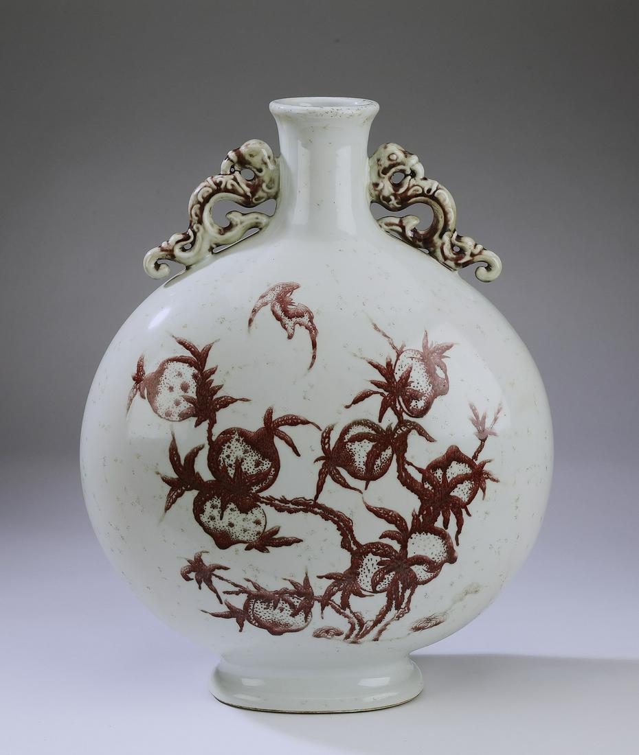 Chinese iron red moon flask with pomegranates: Chinese iron red moon flask, having a trumpet neck flanked by chilong handles, the body decorated with pomegranates and bats, having a six character blue underglaze Qianlong seal mark, 19.75"h x 14.5"