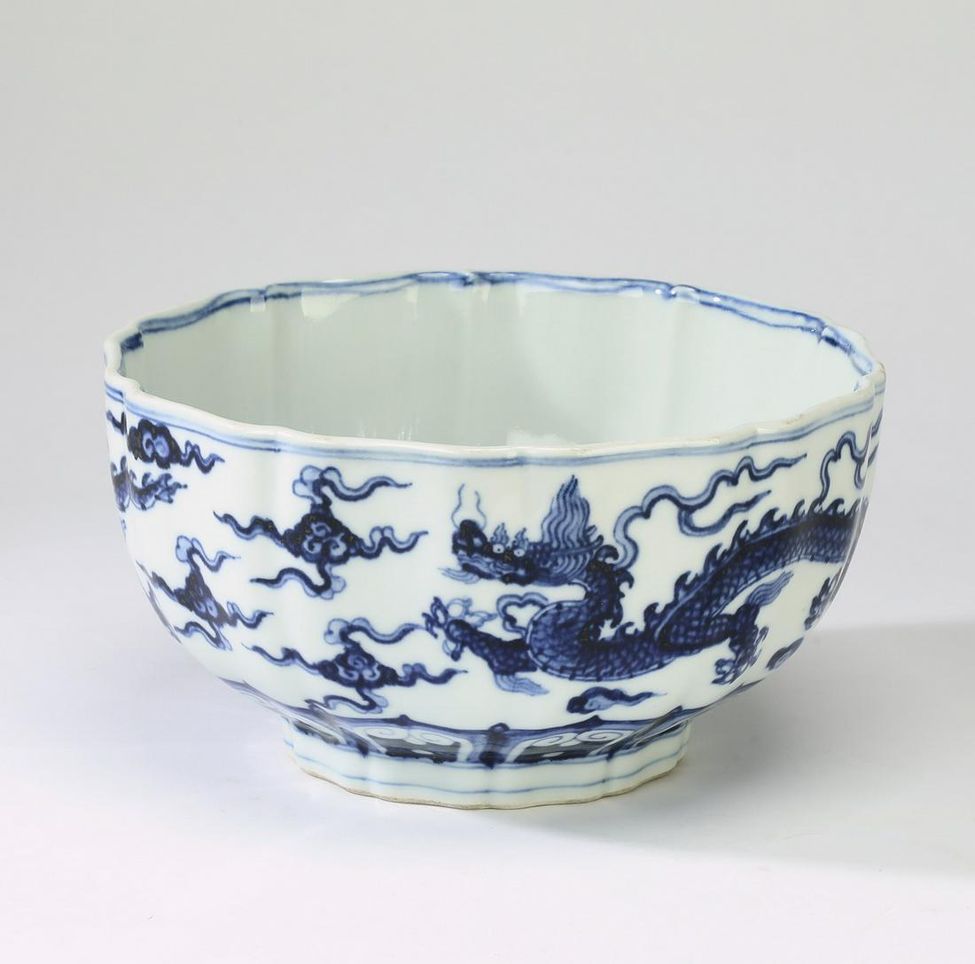 Chinese Ming style dragon bowl, Xuande mark: Chinese Ming style blue and white dragon bowl, having a petal shape rim, the interior centering a branch of pomegranates, the exterior decorated with a writhing five clawed dragon amidst auspicious cl