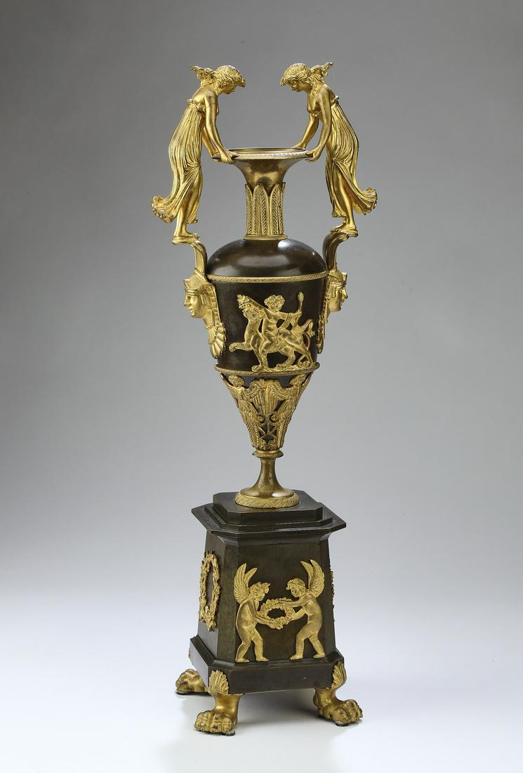 19th c. Continental gilt and patinated bronze urn: Neoclassical style gilt and patinated bronze urn in the manner of Claude Galle, mid 19th century, of elongated teardrop form, the trumpet neck encircled by acanthus leaf mounts, flanked by a pair of h