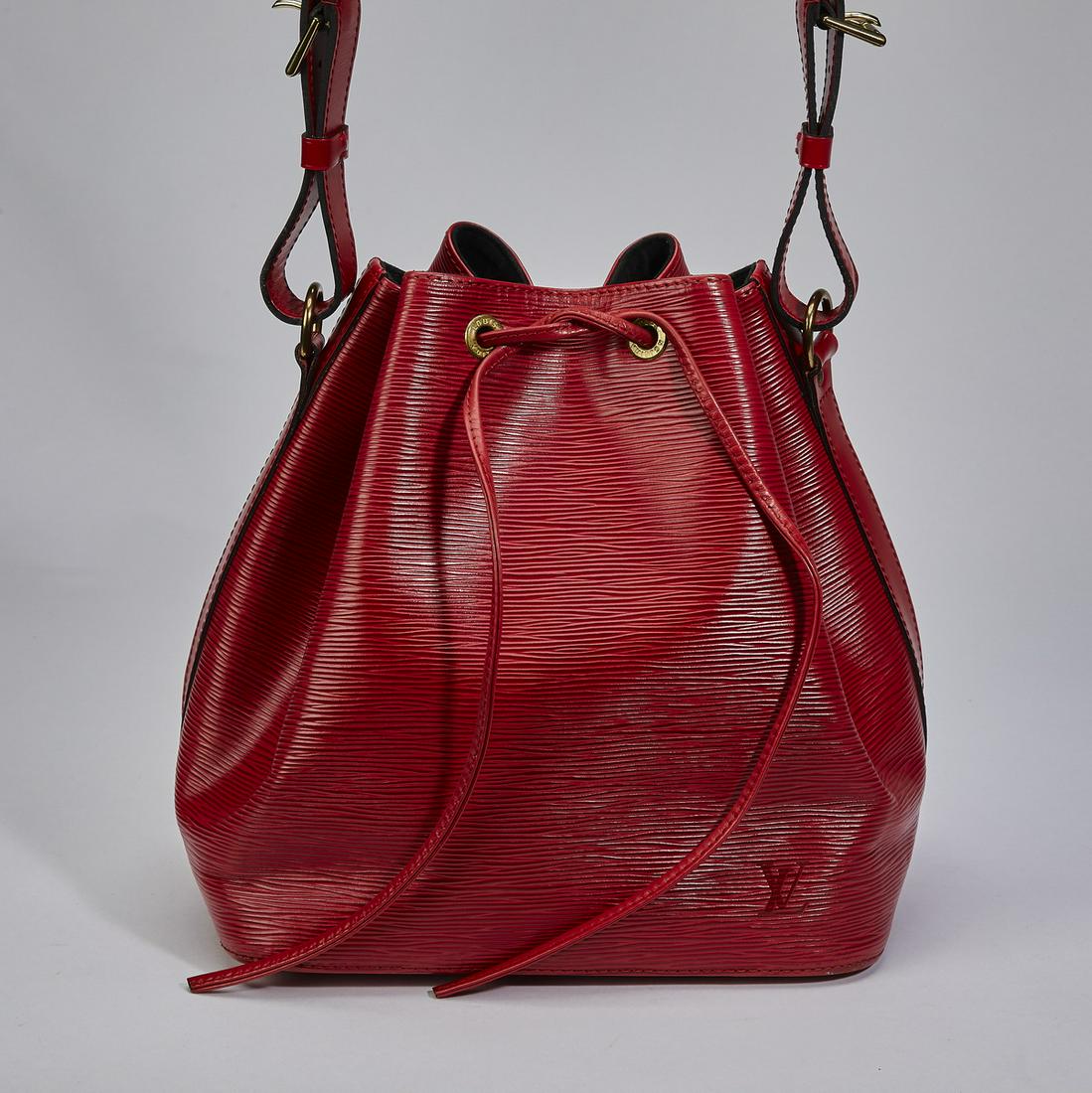 Authentic Louis Vuitton Epi Red Noe PM: Authentic Louis Vuitton Epi Red Noe PM, having an adjustable shoulder strap and gold-tone hardware, the drawstring closure opening to a suede lined interior, serial number AR0914, 10.25"h x 9.5"w x 7"