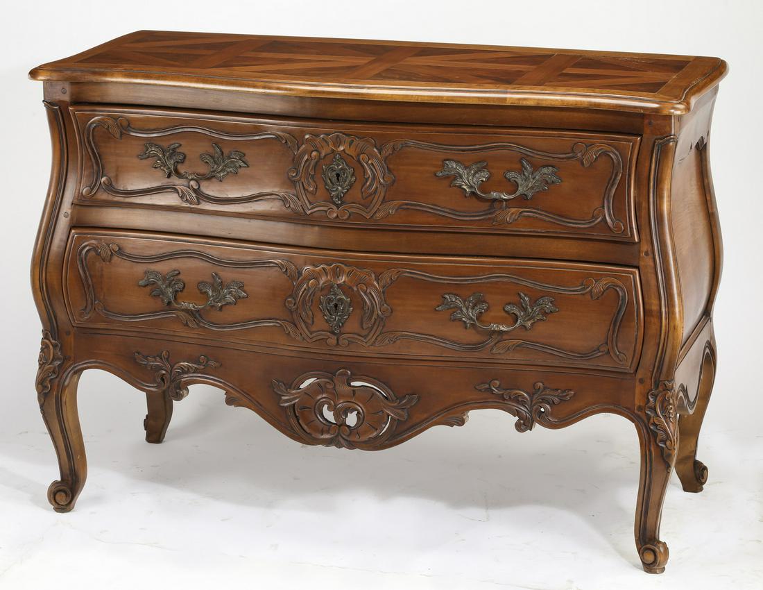 Early 20th c. French walnut parquetry commode: Walnut serpentine bombe' commode in the Louis XV taste, early 20th century, having a serpentine shaped parquetry top with molded edges and rounded corners over a conforming bombe' case, having two lon