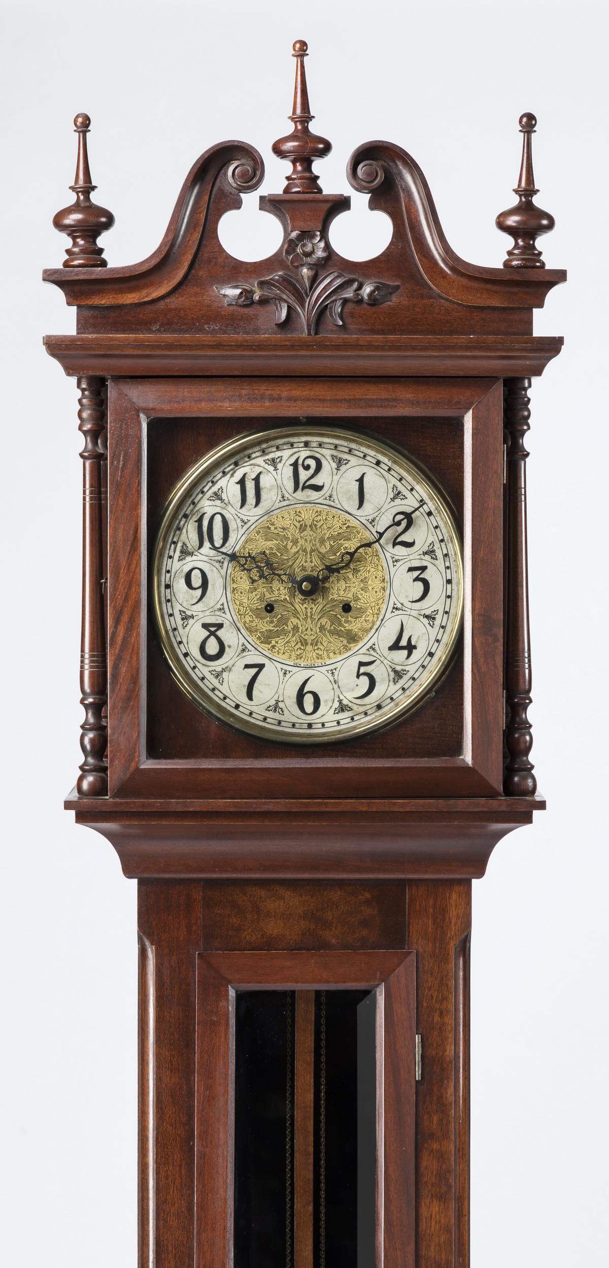 19th c. American New Haven tall case clock, 92"h: 19th century American tall case clock, the mahogany case with broken swan's neck pediment flanked by finely turned finials, surmounting a relief-carved foliate motif above the glass door opening to re