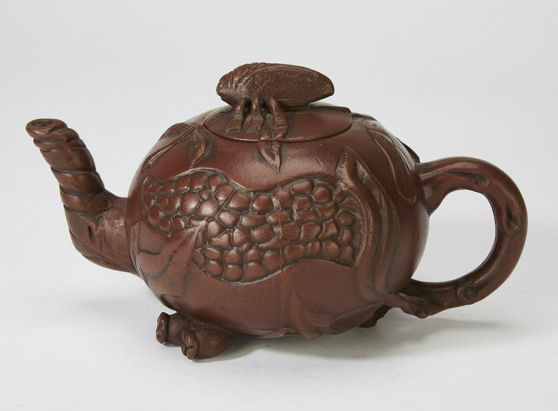 Chinese yixing cicada and pomegranate teapot: Chinese yixing cicada and pomegranate teapot, having cicada form finial resting on a globular body molded in the form of a pomegranate, with twisted vine spout and handle, marked inside lid and undern