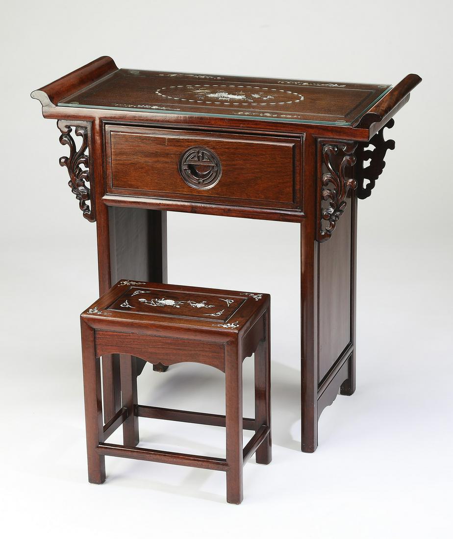 (2pcs) Chinese carved rosewood and MOP inlaid vanity: Chinese carved rosewood and mother-of-pearl vanity table and bench, the table of traditional altar form, having a rectangular top ending in everted flanges and floral mother of pearl inlay, above a si
