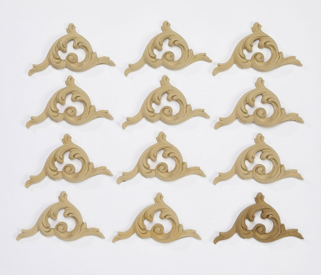 (12) Carved wood acanthus knot appliques, 5"w: Group of (12) carved wood appliques, each of acanthus knot form, ready for your stained or painted finish, 2.75"h x 5"w x 0.5"d.
