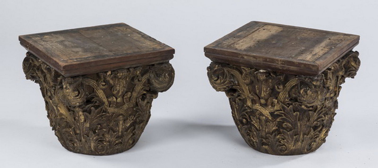(2) 19th c. carved Corinthian capitals, 13"h: Pair of 19th century carved and parcel gilt Corinthian capitals in the style of Louis Sullivan, having a continuously carved acanthus motif, each resting on a square plinth base, 12.5"h x 13.5"w x 13.