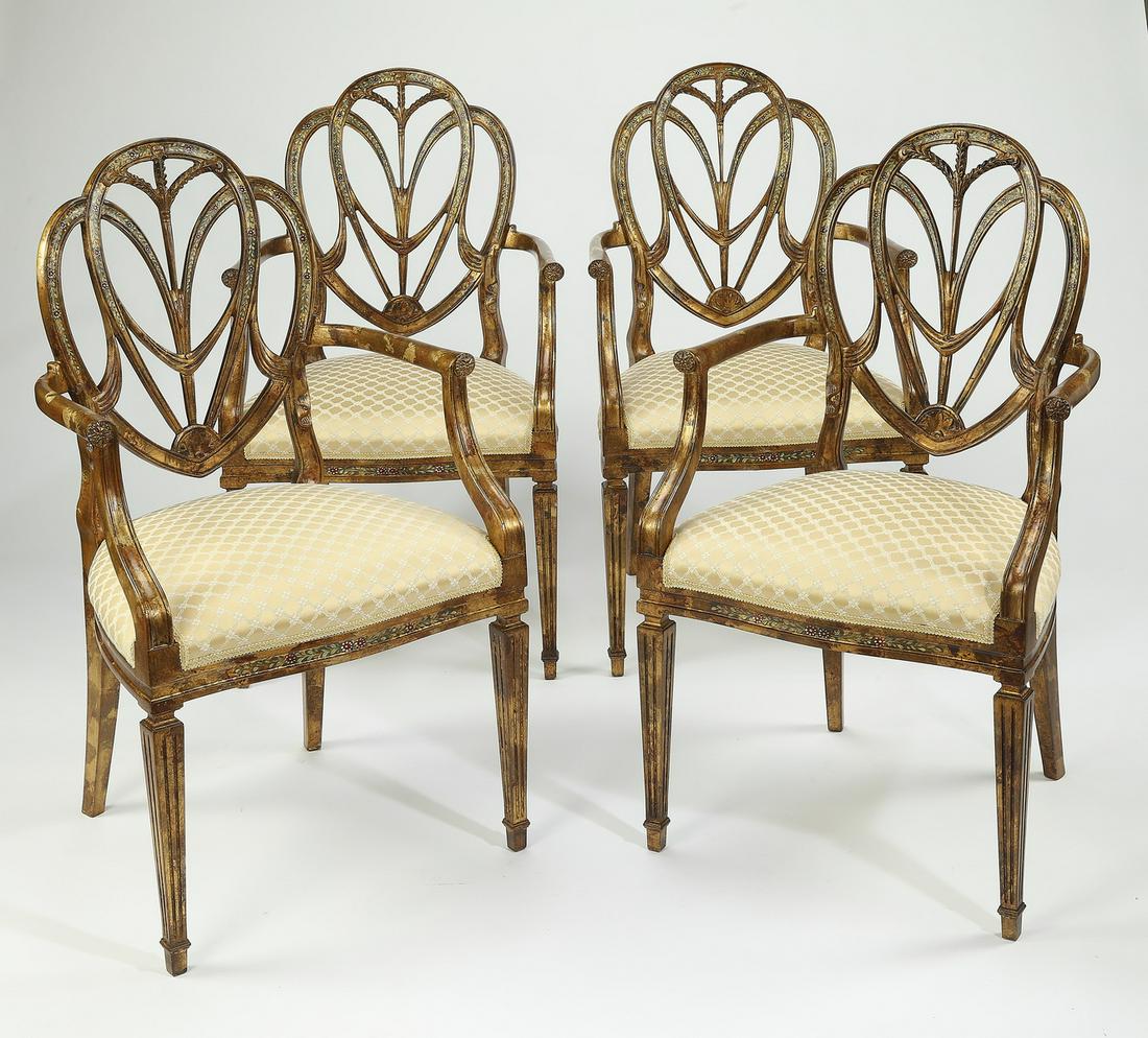(4) Italian paint decorated shield-back armchairs: (4) Italian paint decorated armchairs in the Adam style, each pierce carved shield back having Prince of Wales feathers and drapery, above a serpentine seat, upholstered half over the rails in a lemon