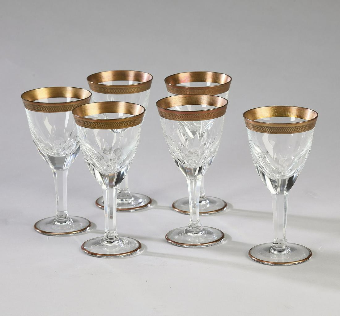 (6) Crystal and gilt banded cordial glasses: (6) cCystal and gilt banded cordial glasses, each having a gilt band etched with an interlacing pattern, over a funnel shaped bowl with thumb prints, rising on a six sided stem, terminating to a circu
