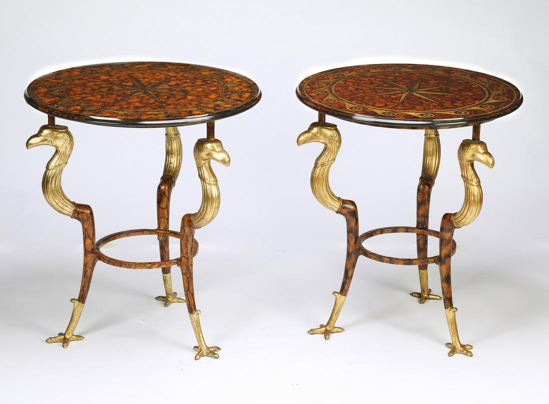 (2) Maitland-Smith Empire style occassional tables: Pair of Maitland-Smith occasional tables, in the Empire taste, each having a circular glass surface decorated with a star and wave border on a faux tortoiseshell ground, rising on gilt-decorated figur