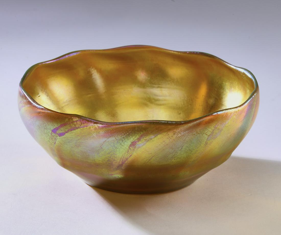 Tiffany Studios gold iridescent favrile bowl, ca 1915: Tiffany Studios favrile bowl, circa 1915, executed in gold iridescent glass, having a slightly wavy rim above a tapering ribbed body, the underside with a polished pontil, signed L.C.T. Favrile, 3.5"h