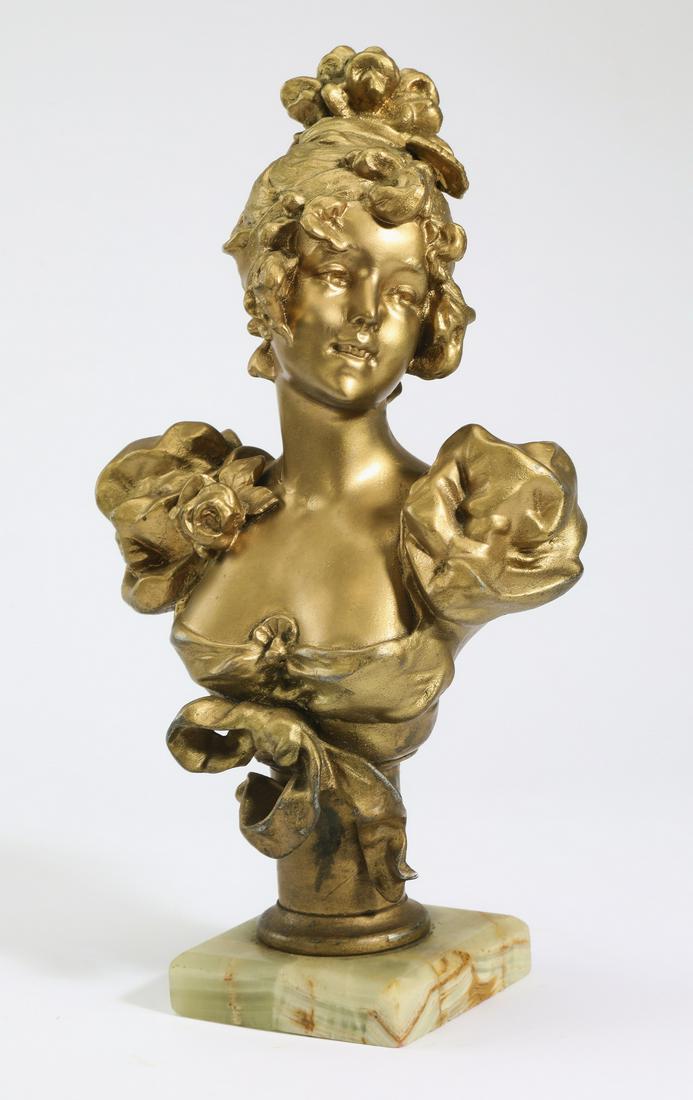 Art Nouveau inspired bust of a young lady: Art Nouveau inspired bust of a young lady, executed in gold washed spelter, depicting a young woman with upswept hair and puffed sleeves embellished with a rose, the whole resting on an onyx base, 11.