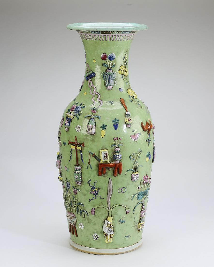 Chinese vase with 'bogu' and Buddhist treasures: Chinese famille rose baluster vase with high relief decoration, having a trumpet neck with leiwen and lappet bands above a body decorated with 'bogu' or ancient things and Buddhist treasures as well a