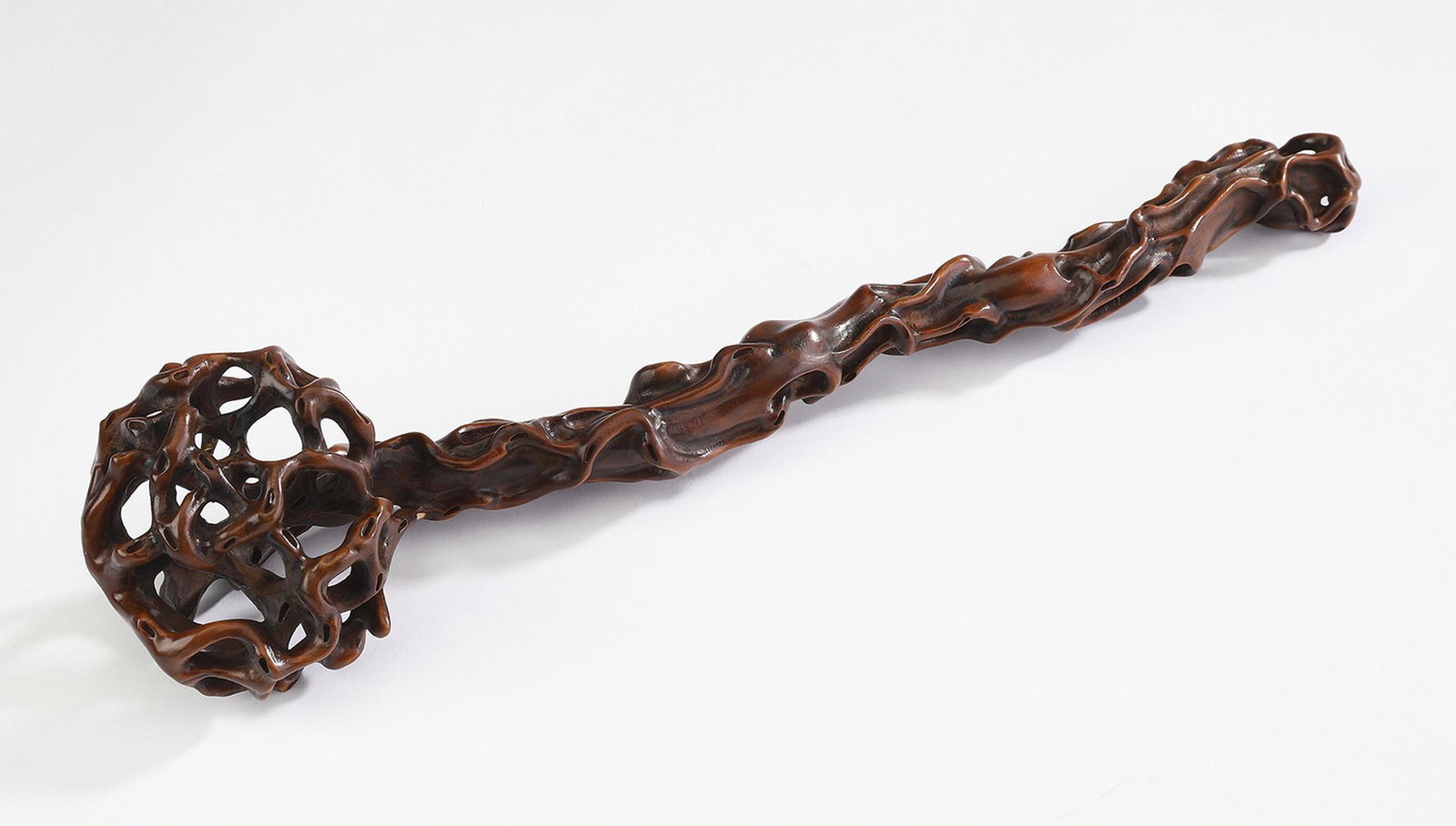Chinese carved boxwood ruyi scepter, 13"l: Chinese carved and pierced boxwood ruyi scepter, of typical form, delicately carved and pierced throughout, 2.5"h x 13"l x 3"w.