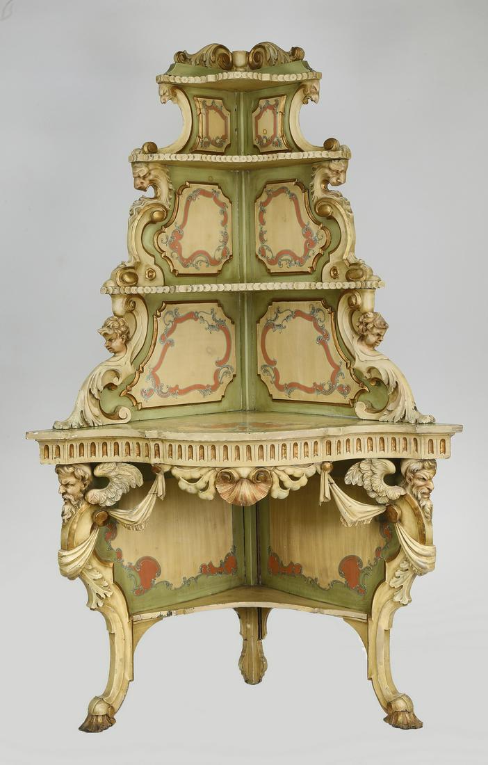 Venetian style paint-decorated corner etagere: Venetian style paint-decorated corner etagere, having four shelves with acanthus and figural brackets, paint-decorated with rocaille panels, surmounting a serpentine surface, rising on a pierce-carved