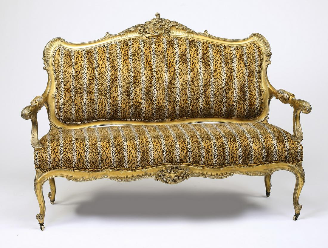 Late 19th c. custom upholstered Louis XV style settee: Custom upholstered Louis XV style settee, late 19th century, having all over gilt decoration, the rocaille cartouche surmounting the tiger print upholstered back, padded arms, and seat, rising on cabr