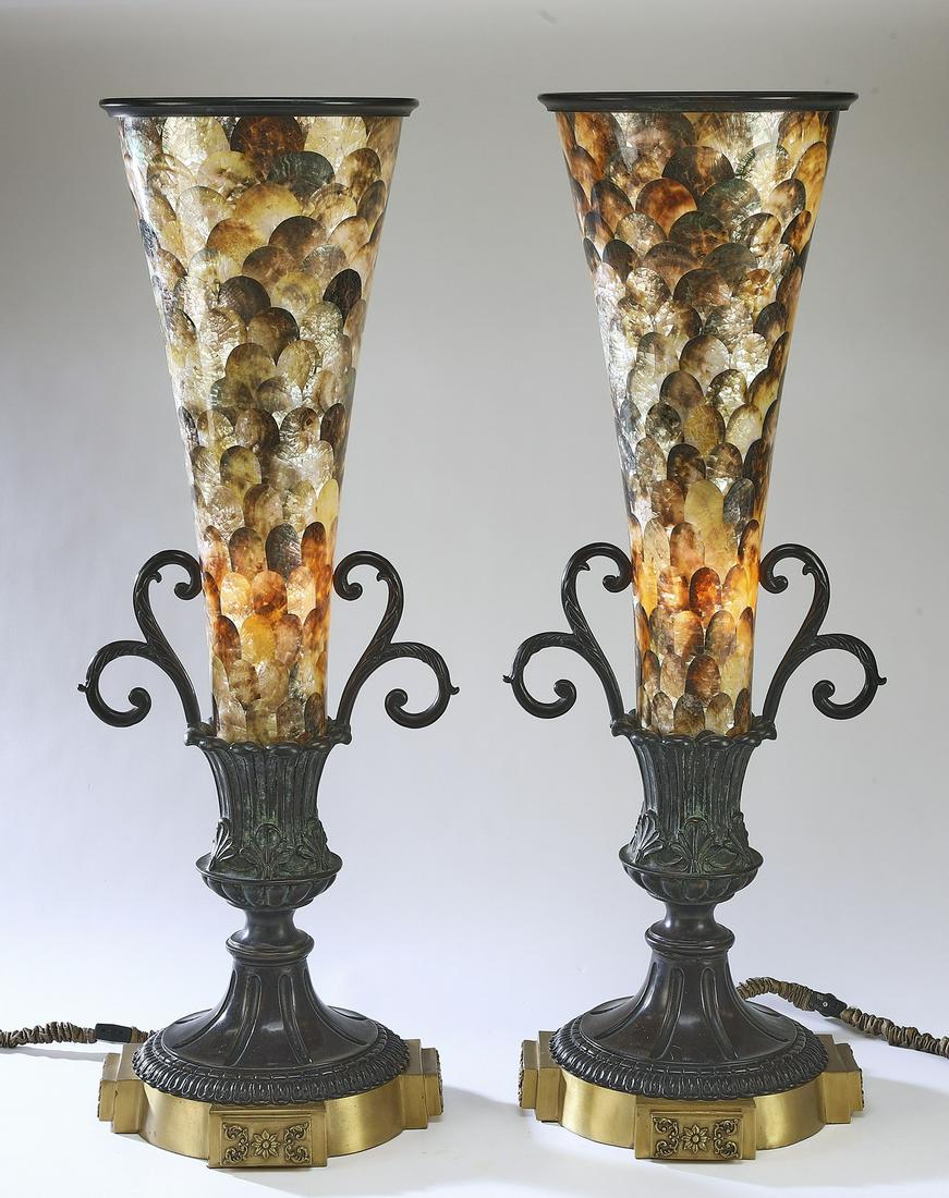 (2) Maitland-Smith pen shell and bronze table lamps: Pair of Maitland-Smith table lamps, each having a flared pen shell shade, surmounting a bronze standard with acanthus scrollwork details, the whole rising on a plinth base, maker marked to underside,