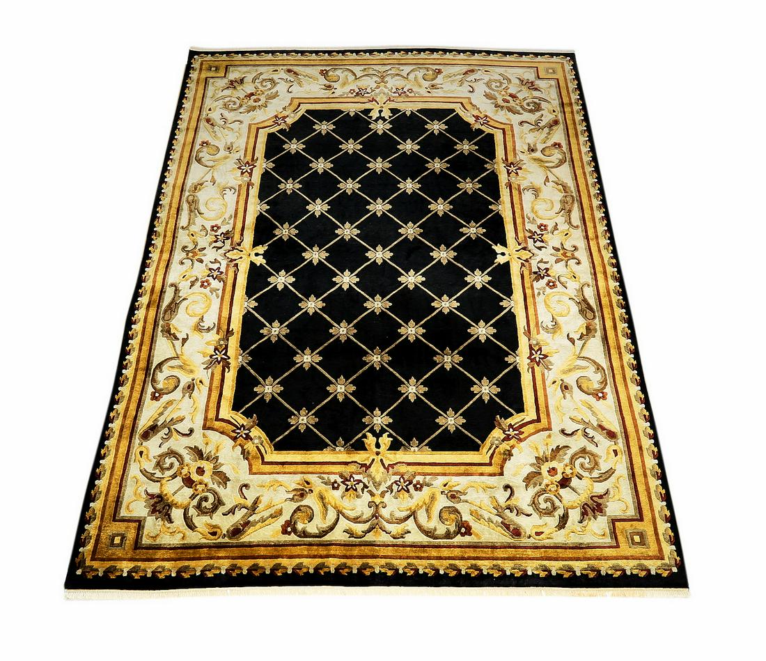 Hand knotted wood rug in the Aubusson style, 14 x 10: Hand knotted wood rug in the Aubusson style, having an all over diamond grid with rosettes at the intersecting points, in taupe and cream on a black field, framed by a gold, taupe and cranberry scroll
