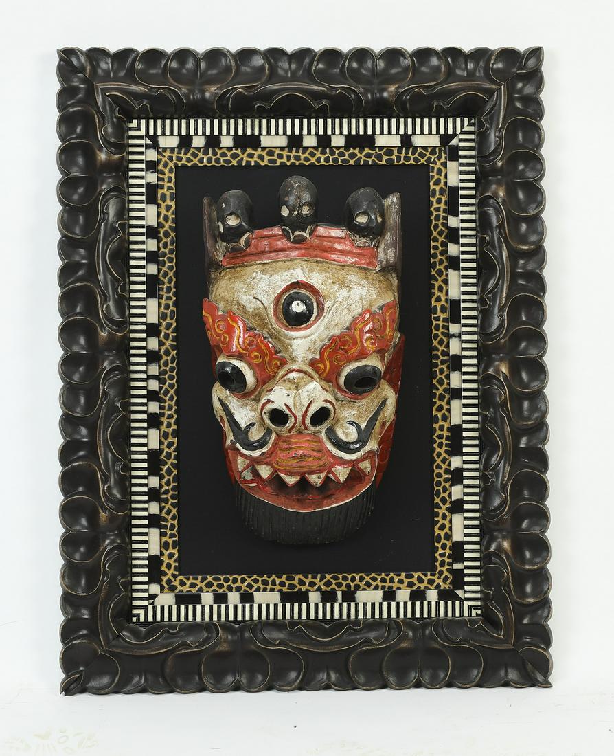 Carved and paint-decorated Balinese mask of Hayagriva: Carved and paint-decorated Balinese mask, 20th century, likely depicting Hayagriva, shown with a crown of skulls, a third eye, and tusks, 14"h x 9"w x 6"d, overall dimensions with frame 29"h x 22"w x 