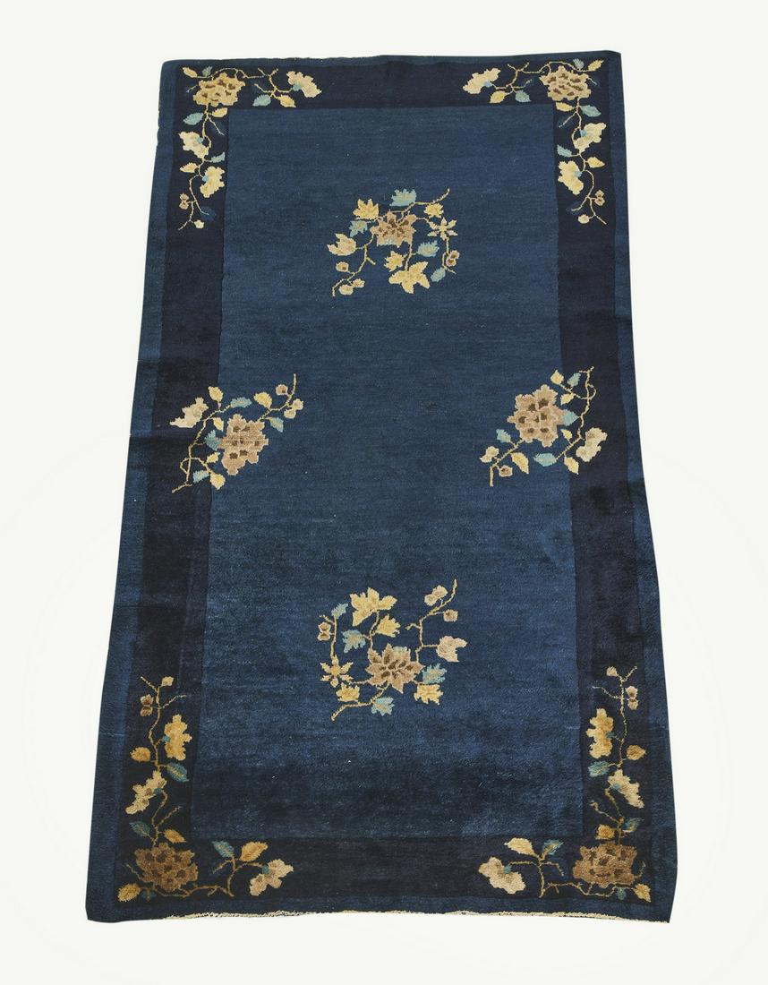 Hand knotted wool Chinese Art Deco rug, 5 x 3: Hand knotted wool Chinese Art Deco rug, having a full field of floral sprays in rose, indigo, and tan on a cobalt ground with a navy border, 5'l x 3'w.