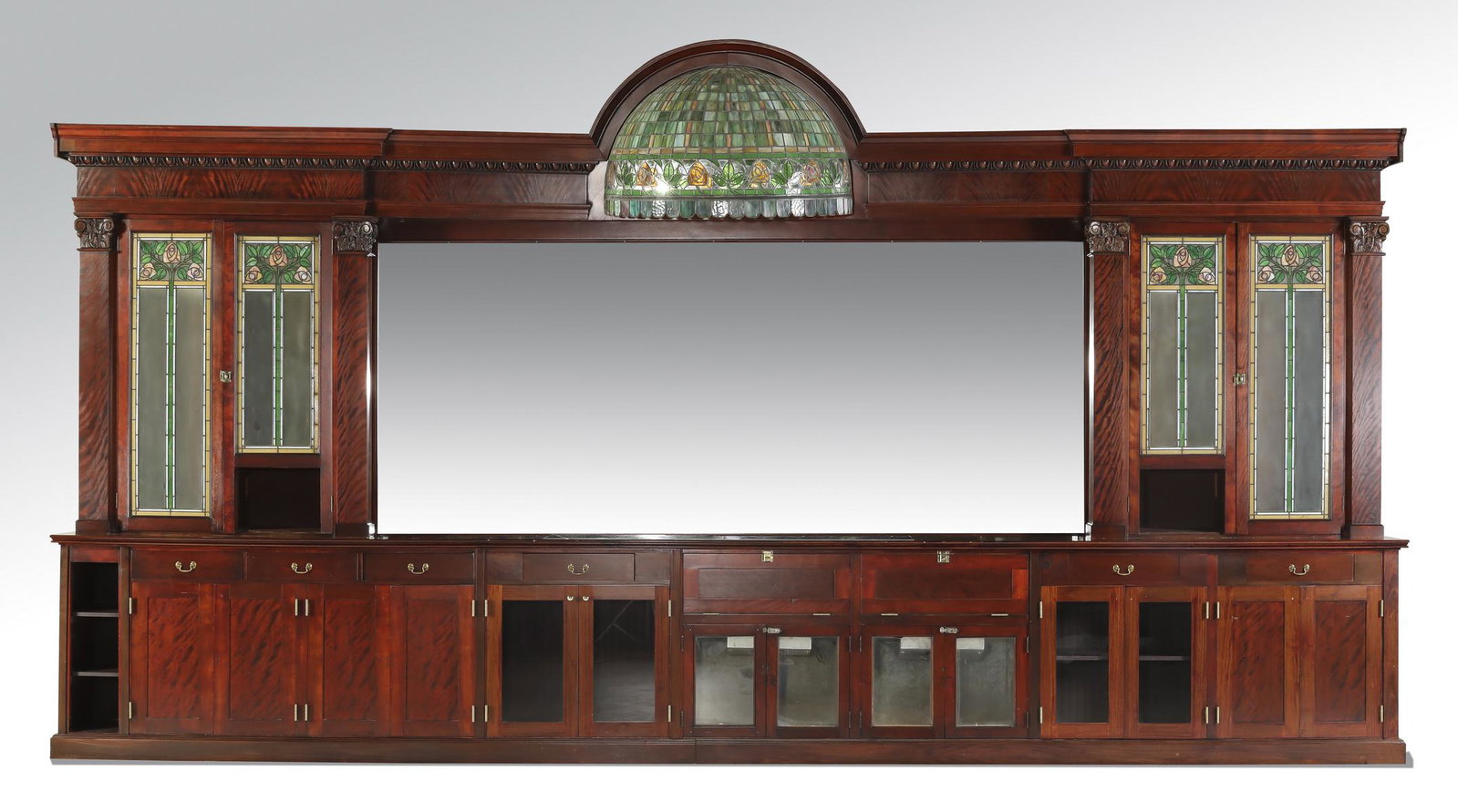 19th c. Brunswick, Balke & Collander back bar: Very rare late 19th century American saloon bar by the Brunswick, Balke & Collander Co., with an arched top supporting an original semi-circular leaded glass dome, with two pairs of flanking liquor ca