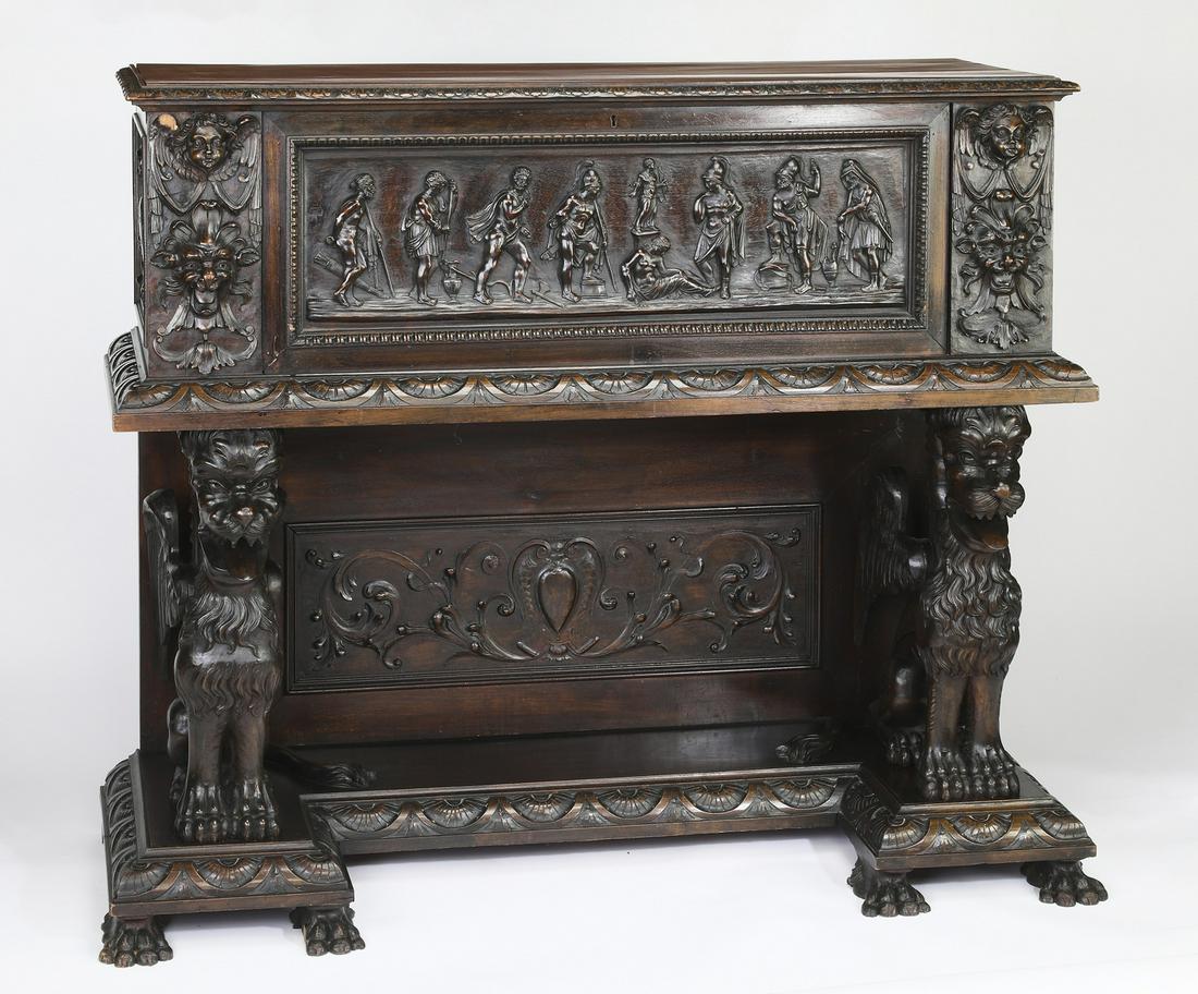 19th c. Gothic Revival carved walnut court cupboard: Gothic Revival carved walnut court cupboard, 19th century, the upper cabinet having a gadrooned edge surmounting a drop down door relief carved with a classical scene, opening to two interior shelves,