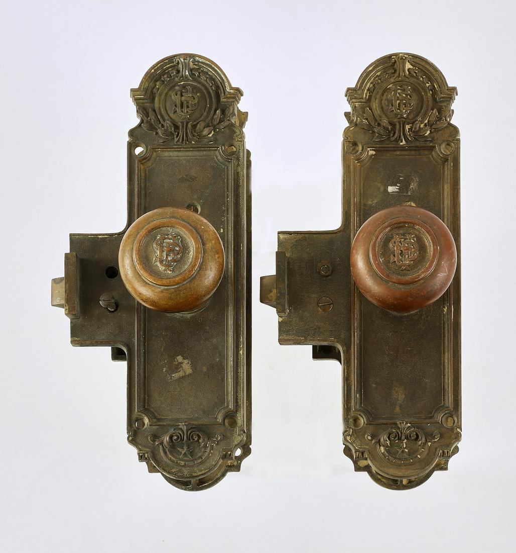 Pair of 19th c. bronze door knobs, 10.75"h: Pair of bronze door knobs, 1899, each decorated with acanthus scrollwork and stars and monogrammed 'USP,' each measuring 10.75"h x 4.75"w x 7"d.