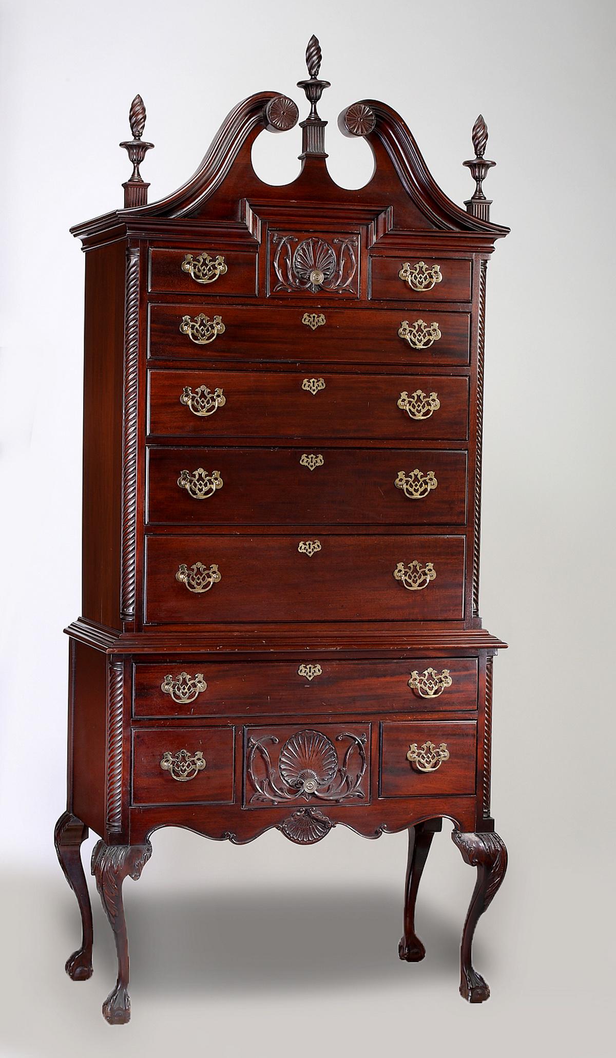 20th c. Chippendale style mahogany high boy: Chippendale style mahogany high boy, having twist turned finials accenting the swan neck pediment, surmounting the upper cabinet of three short drawers over four long drawers, flanked by twist carved 