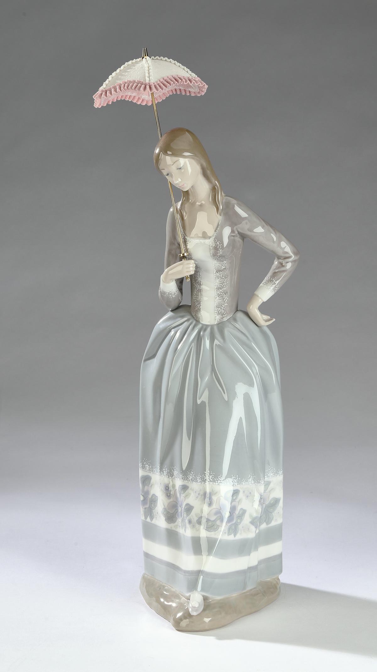 Retired Lladro #4805, 'Lady with Parasol' 19"h: Retired Lladro porcelain figure #4805, 'Lady with Parasol,' depicting a young women in a floor length dress holding a parasol, maker marked, 19"h x 8"w x 7"d.
