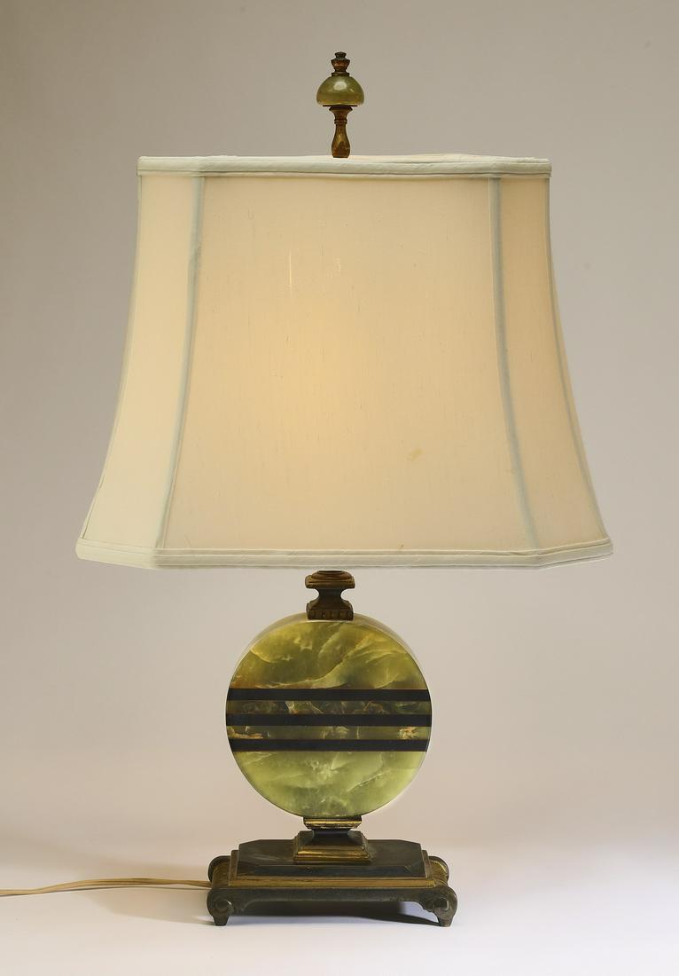 Art Deco onyx table lamp w/ silk shade: Art Deco onyx table lamp, the standard modeled as a green onyx disk inlaid with three horizontal black onyx lines, resting on a rectangular base with scrolled feet, having a later cream silk shade, ba