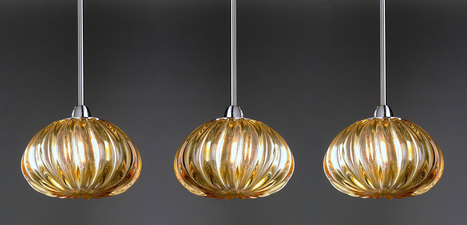 (3) Murano glass 'Diamante' pendants by Vistosi: (3) Contemporary amber Murano glass pendants, designed by Barbara Maggiolo for Vistosi from the 'Diamante' series, each of ribbed melon form, and having the appropriate ceiling mounts, globes 4"h x 6"