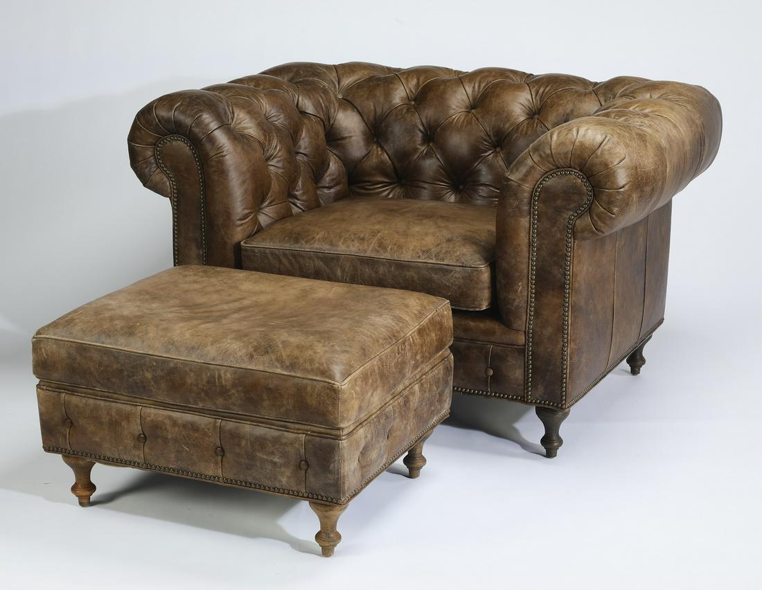 Arhaus leather Chesterfield armchair and ottoman: Arhaus leather Chesterfield armchair and ottoman, having all over button-tufted detail and a continuous arm centering a drop-in seat cushion, the whole rising on turned feet, maker marked to seat, 33"