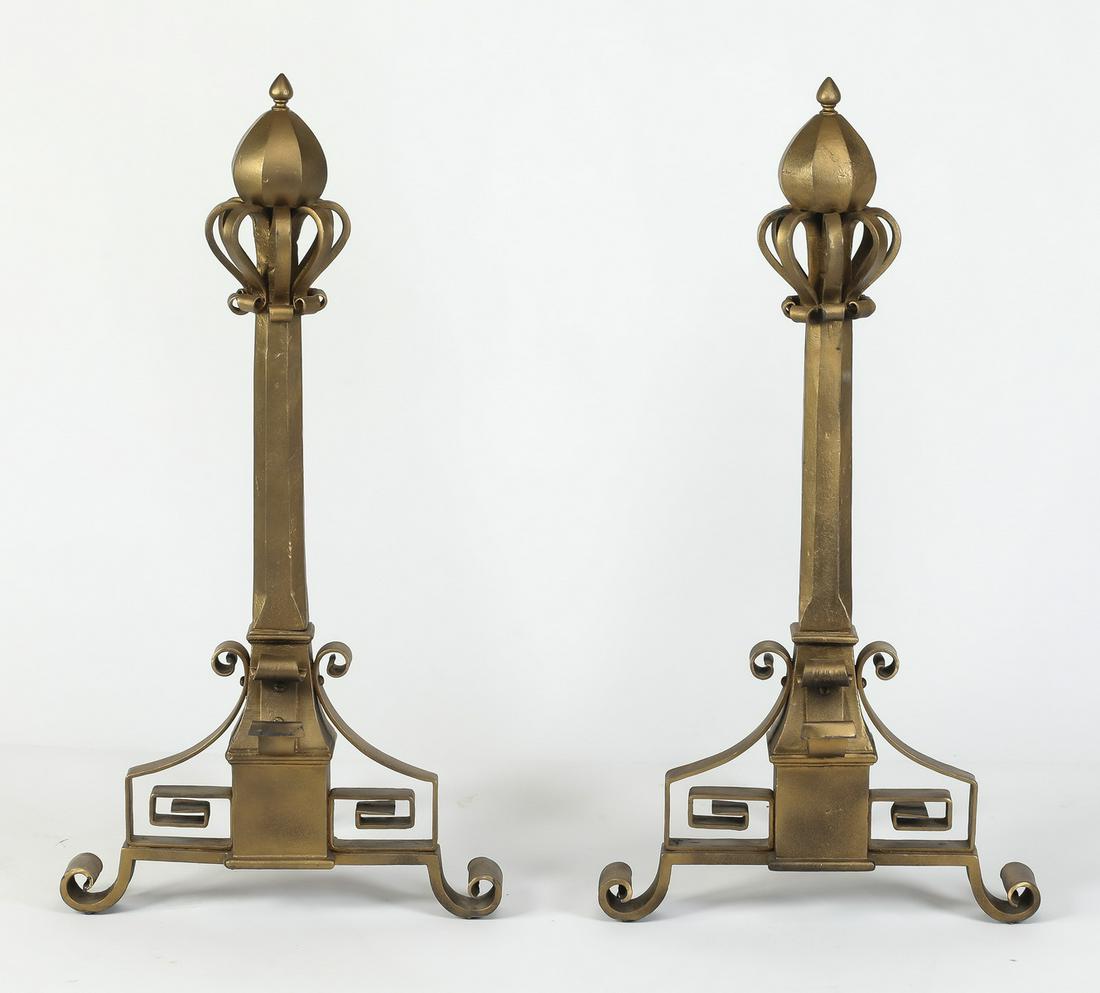 Pair of oversized cast iron andirons, 36"h: Pair of oversized cast iron andirons with a gilt finish, each having finials above a standard surrounded by S-scrolls and spirals terminating in scrolled feet, 35.5"h x 19"w x 17.5"d.