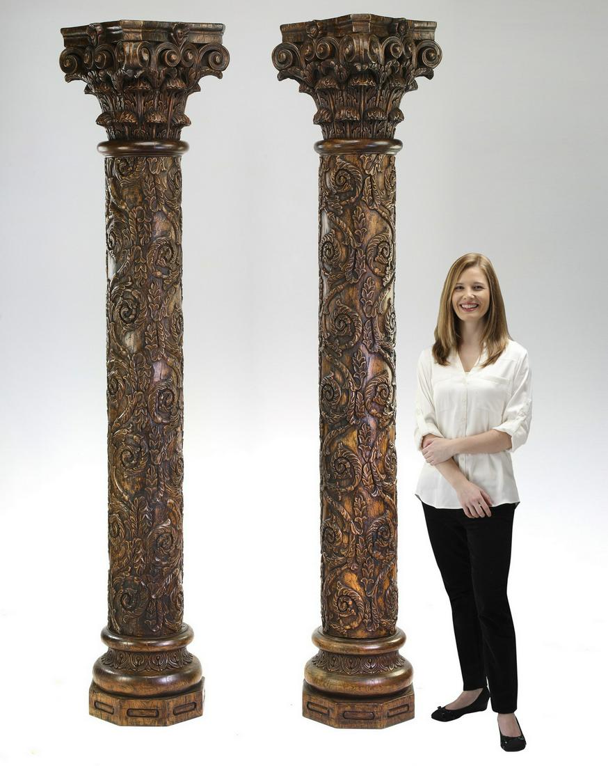 (2) Burmese carved solid wood Corinthian columns: Pair of Burmese carved solid wood Corinthian columns, each having an acanthus scroll and leaf capital rising on the relief carved standard depicting allover S-scrolls, terminating in an octagonal plin