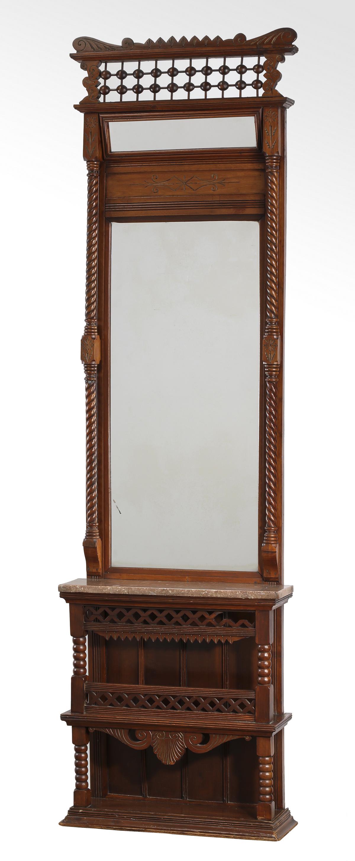 Early 20th c. carved oak marble top pier mirror: American Renaissance Revival pier mirror, early 20th century, executed in oak, having a shaped top with carved foliate accentsl, above a rectangular mirror flanked by turned columnar supports, the who