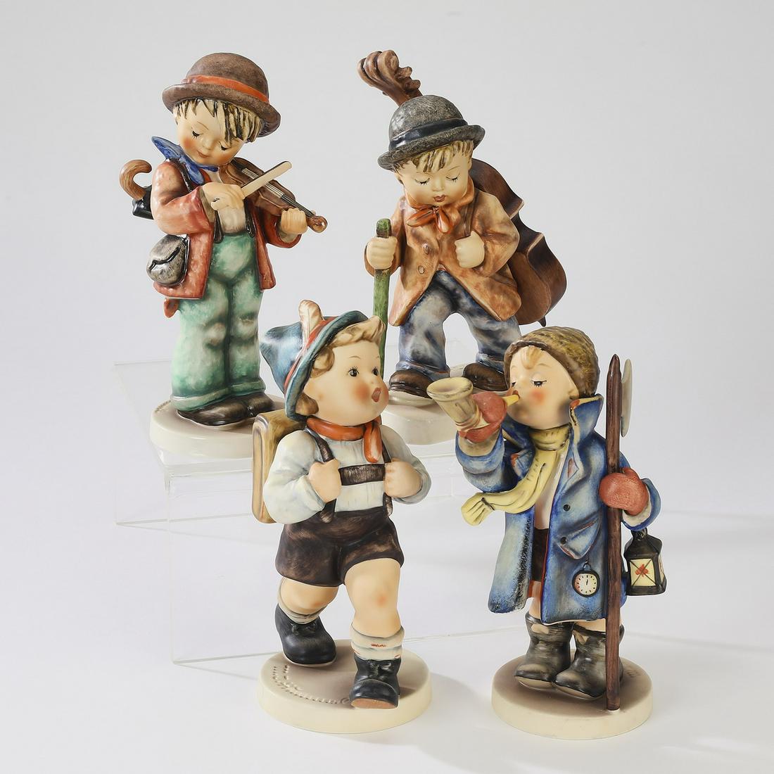 Group of (4) vintage Hummel figures, largest 8"h: Group of (4) Hummel figures, each with Hummel TM 5, comprising (1) 'School Boy,' Hummel mark with an impressed '82/II,' and signed 'su79'; (1) 'Little Cellist,' with an impressed mark '89/2,' signed '