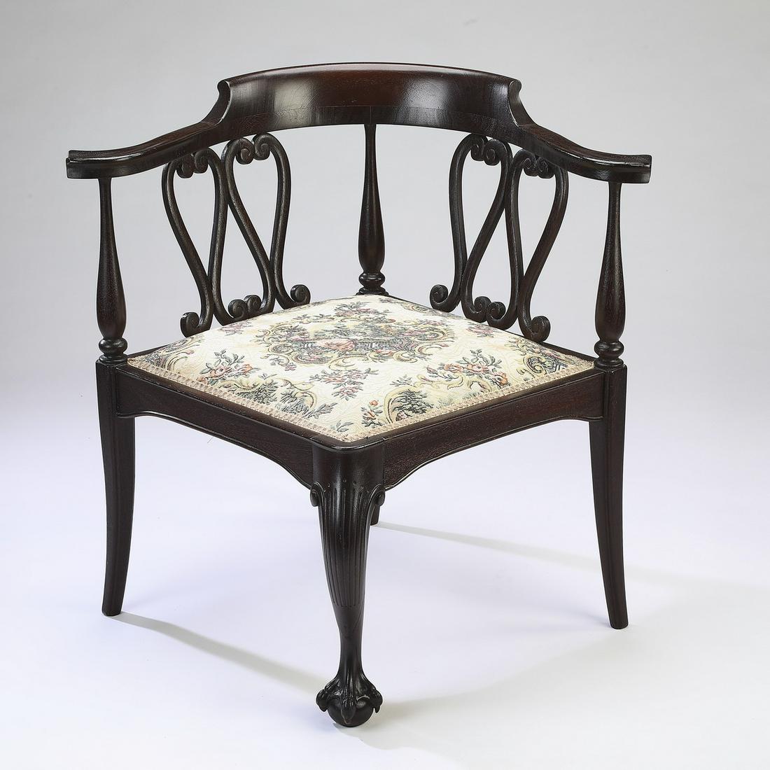 Early 20th c mahogany corner chair with tapestry seat: Early 20th century mahogany corner chair, having a gently curved crest rail rising on scrollwork back splats, leading to the tapestry seat with a central medallion depicting a genre scene on a cream f