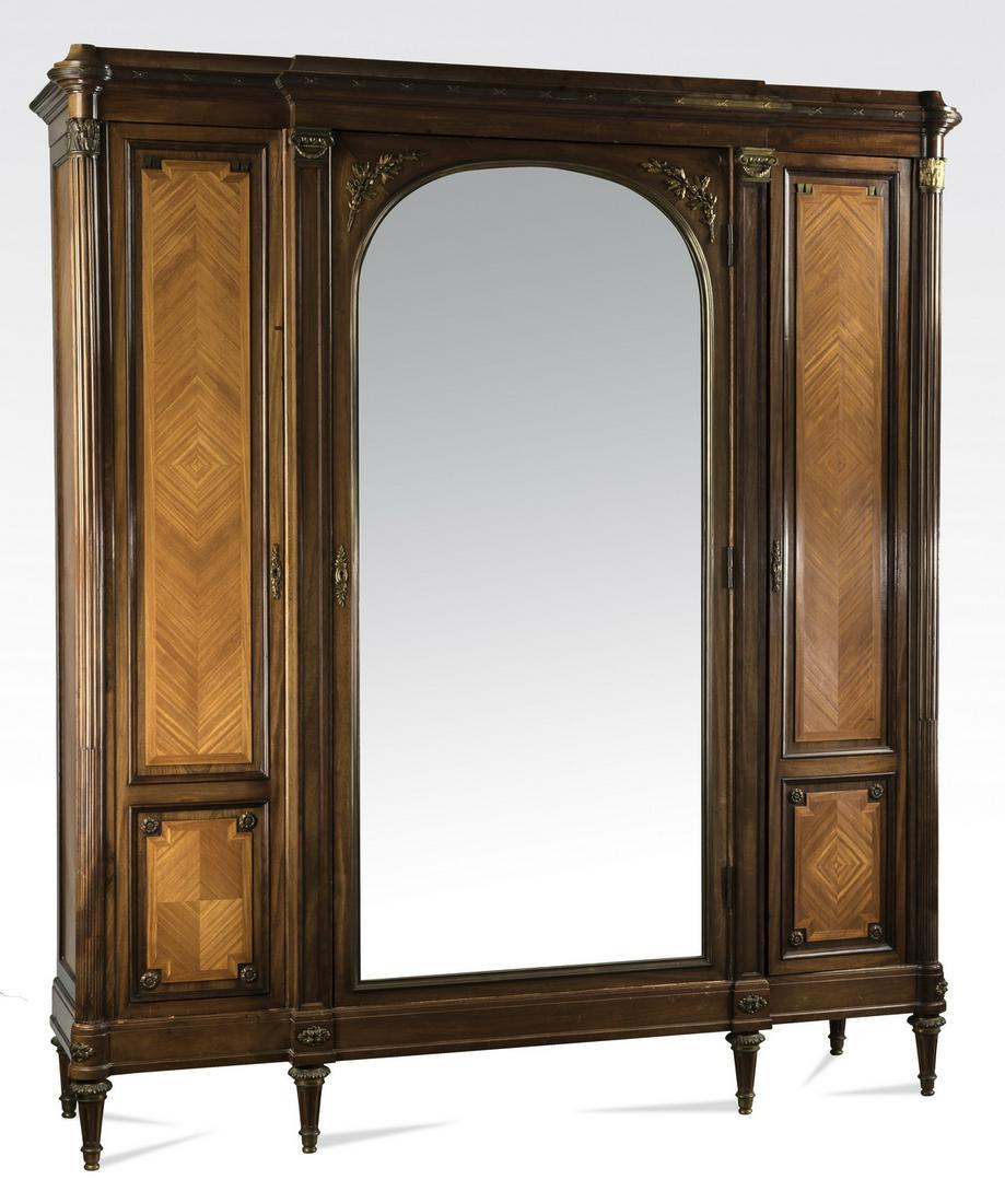 Continental parquetry inlaid 3-door armoire, 86"h: Continental parquetry inlaid armoire in the Neoclassical taste, late 19th or early 20th century, executed in walnut with mahogany inlay, the stepped form having a reeded ribbon wrapped cornice above t