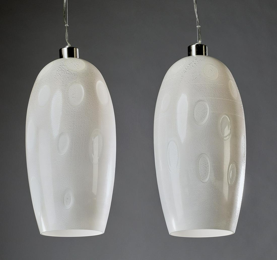 (2) Vistosi white Murano glass pendants: Pair of contemporary white Murano glass pendants, designed by Paolo Crepax and Silvio Zanon for Vistosi, from the 'Marble' series, each of ovoid form, executed in white glass with silver flecks and li