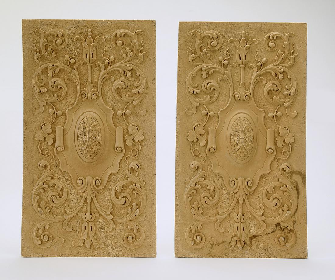 (2) Fleur-de-lis and scrollwork architectural panels: Pair of architectural panels, crafted of cast composition, depicting elaborate acanthus scrollwork centering a carbachon accented with fleur-de-lis, ready for your stained or painted finish, 20"h x 11