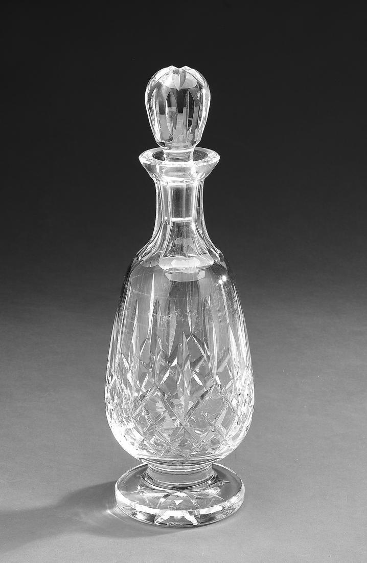 Waterford 'Lismore' crystal brandy decanter: Waterford crystal tall brandy decanter in the 'Lismore' pattern, having an ovoid stopper above a teardrop body terminating to a circular foot, maker marked, 13.25"h x