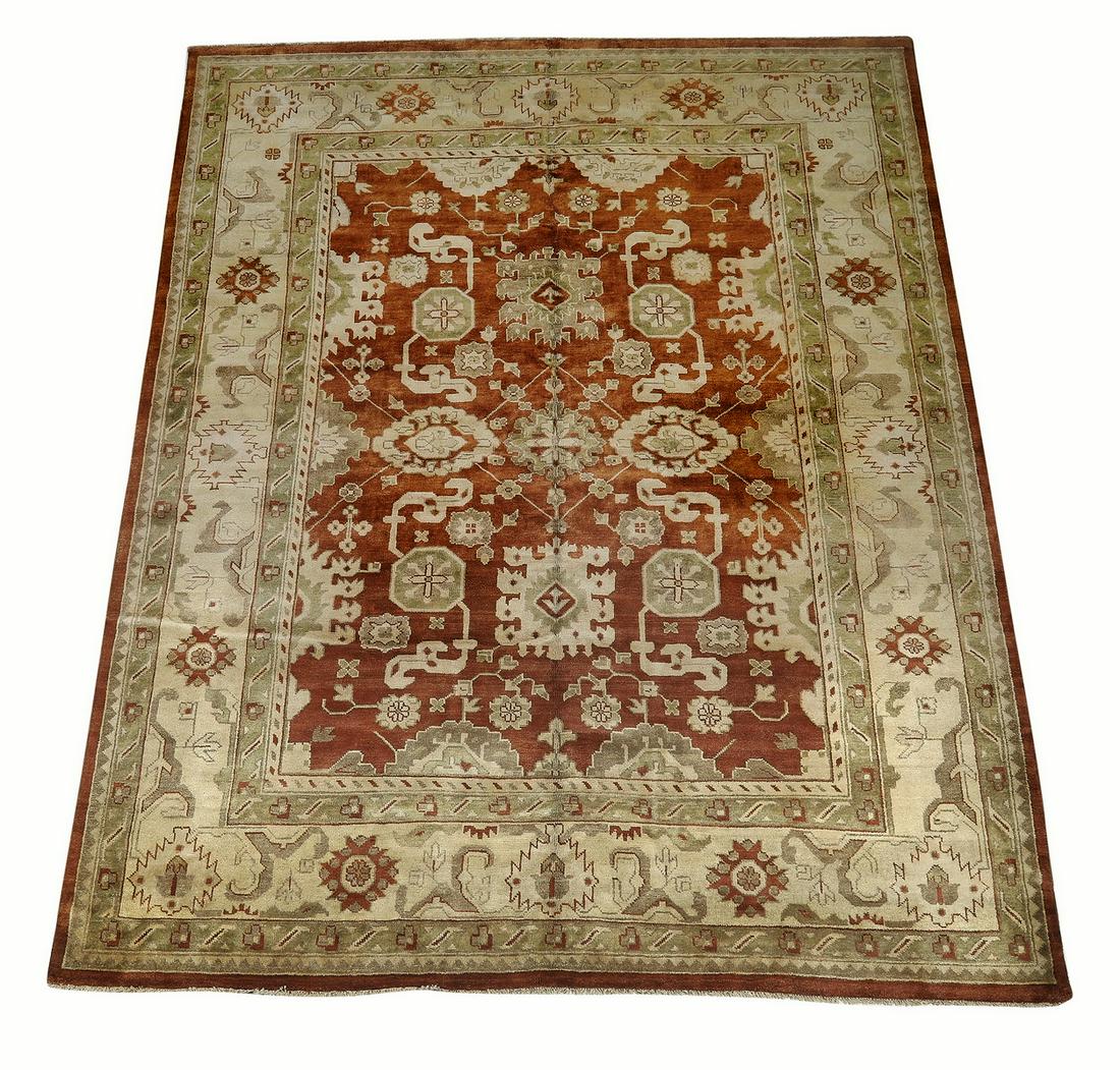 Hand knotted wool Indo-Oushak, 12 x 9: Hand knotted wool Indo-Oushak, having a full field of palmettes and stylized floral elements in taupe, beige and sage on a rust and blue ground, with a meander border on a sage ground, 12' 3"l x 9' 3"